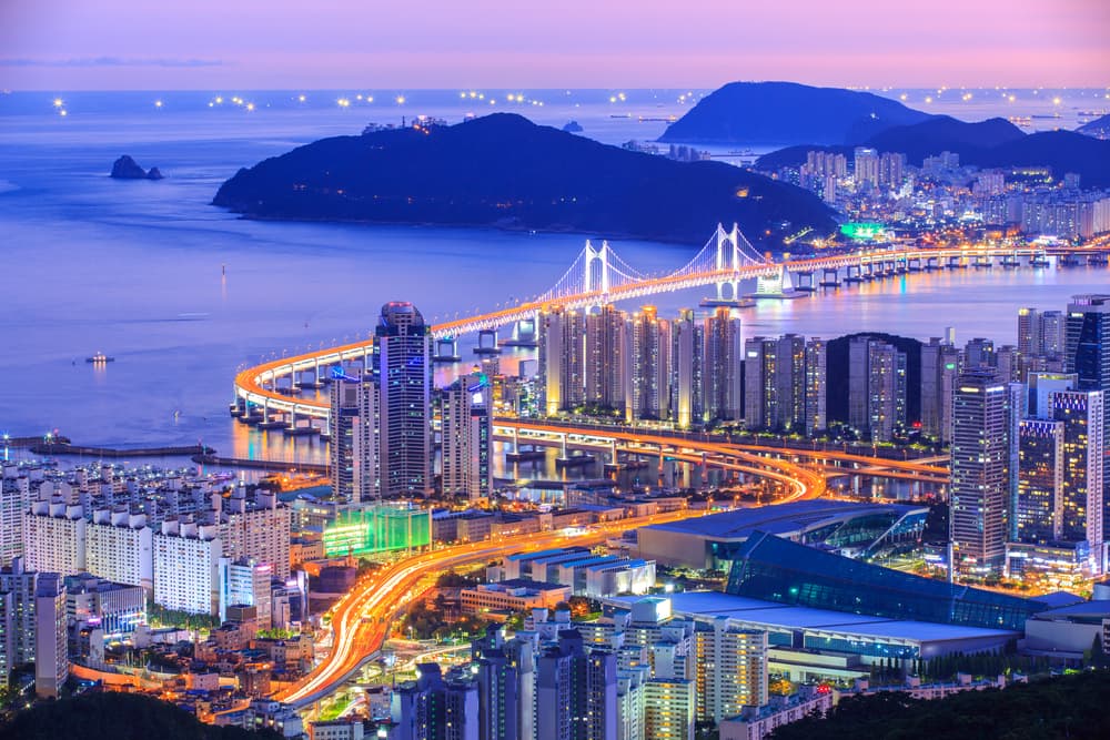 Seoul city skyline at dusk with mountains in the distance