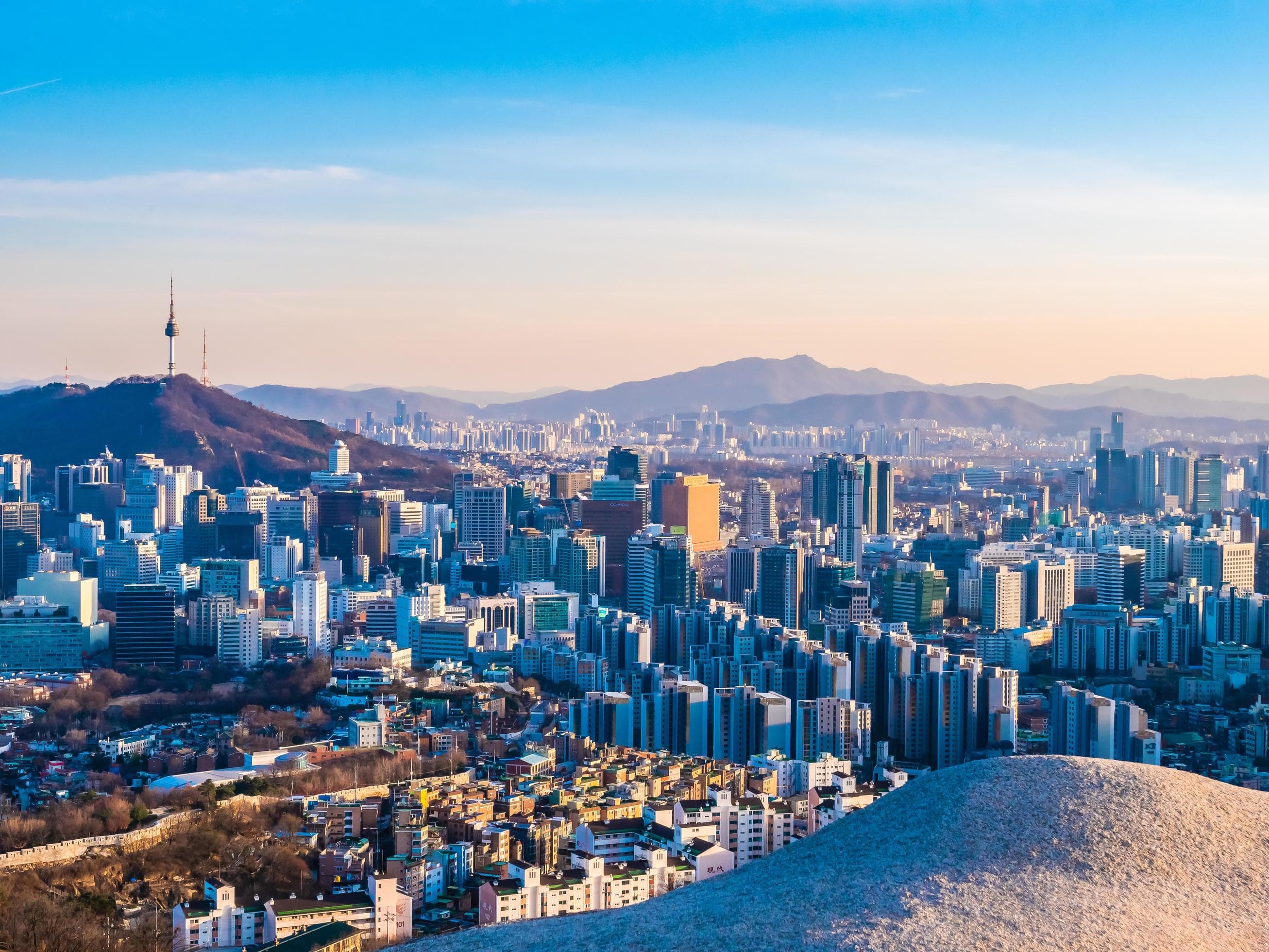 Traditional Korean palace against the modern Seoul skyline
